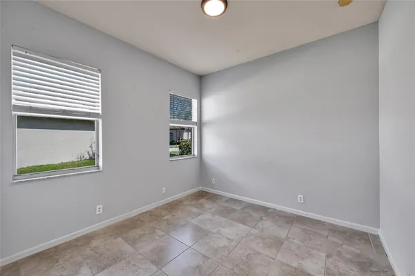 an empty room with windows and closet