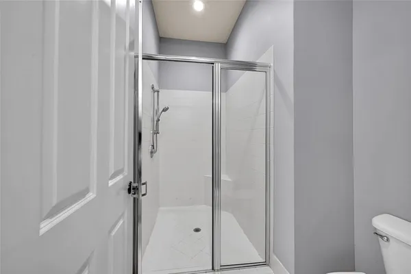 a bathroom with a glass shower door
