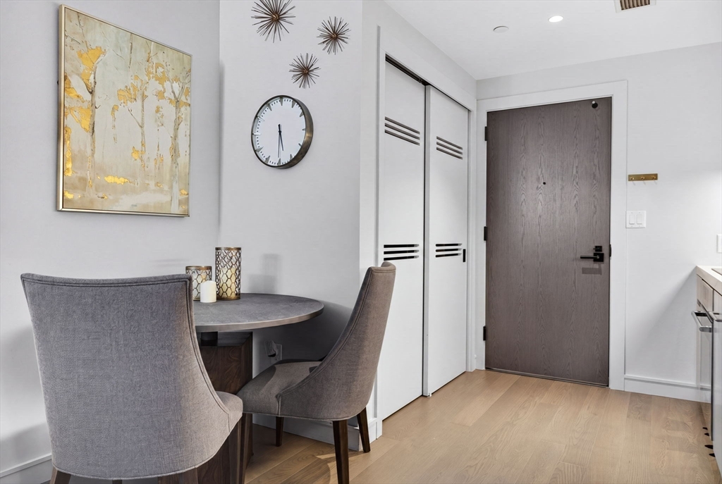 55 Lagrange Street, Unit 409 Boston, MA 02111 - Photo 8 of 29 a view of dining room with furniture and wooden floor