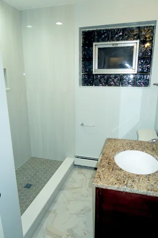 a view of a room with wooden floor and a window