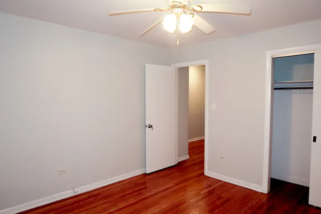 a view of a room with wooden floor and a window