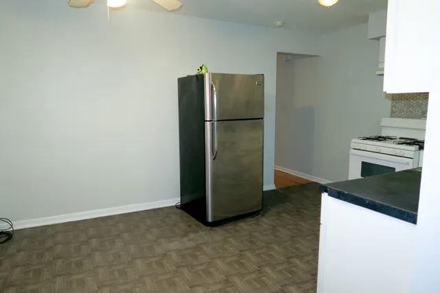 a kitchen with a refrigerator and a stove