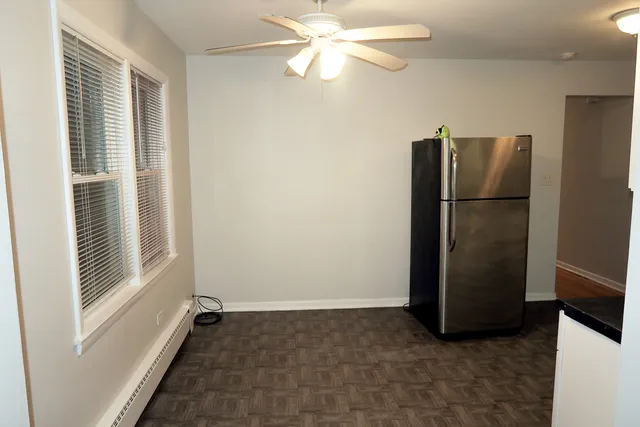 a view of a livingroom with a ceiling fan and window