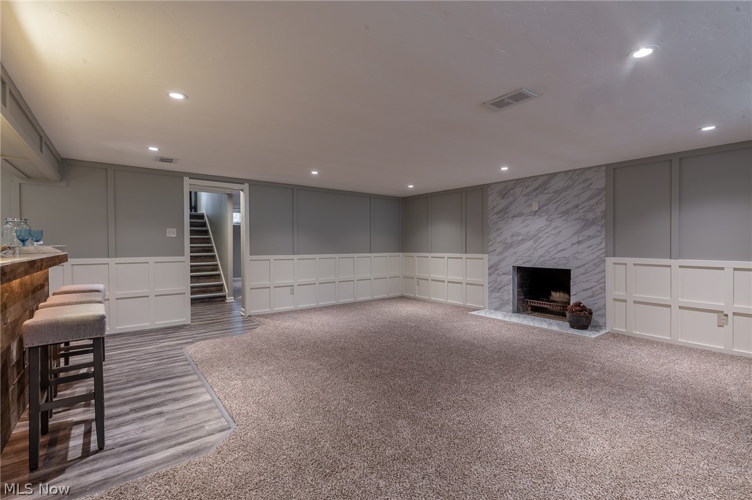 1393 Clearview Road Cleveland, OH 44124 - Photo 29 of 35 And if the previous room wasn't enough, we offer the "Hearth" room! Recessed lighting, wood burning fireplace, custom wainscoting walls, ceramic marble tile at the fireplace, and a large open carpeted area!