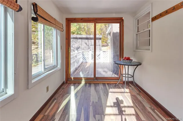 a view of a room with wooden floor and furniture