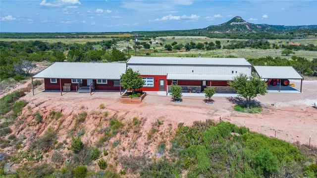 an aerial view of a house with garden space and street view