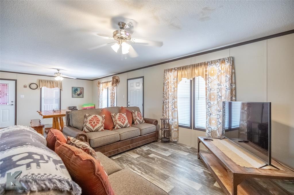 2302 County Road 360 Merkel, TX 79536 - Photo 13 of 39 a spacious bedroom with a large bed and a flat screen tv