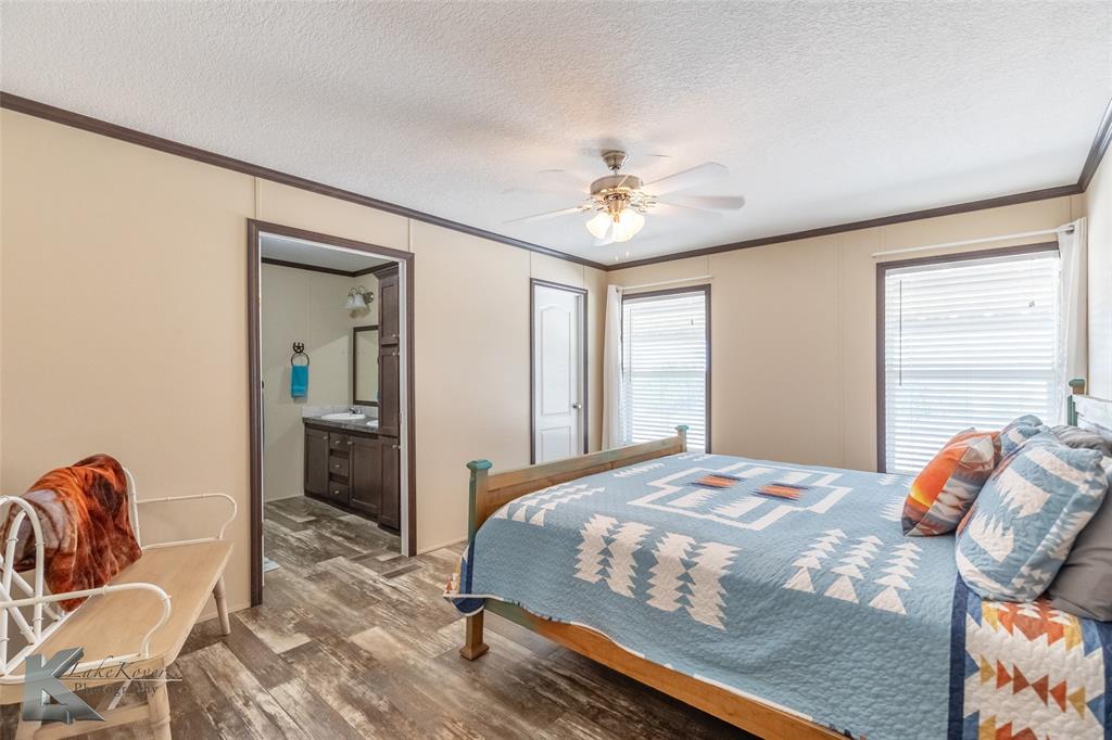 2302 County Road 360 Merkel, TX 79536 - Photo 16 of 39 a bedroom with a bed and wooden floor