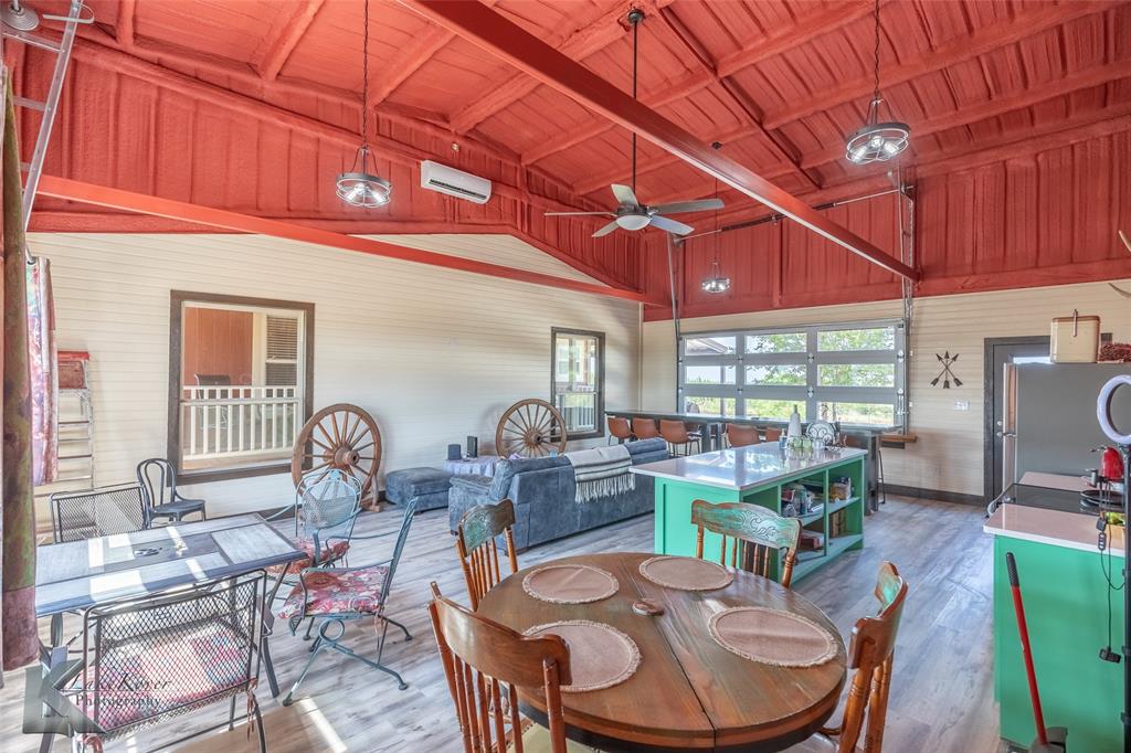 2302 County Road 360 Merkel, TX 79536 - Photo 23 of 39 a dining room with furniture a rug and wooden floor