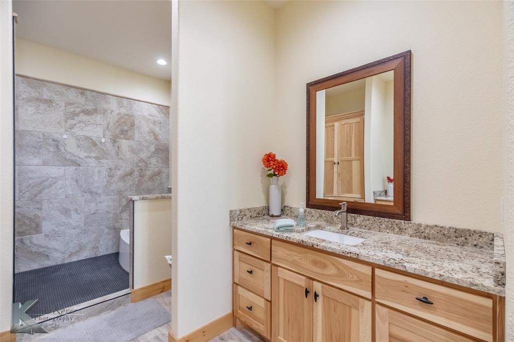 2302 County Road 360 Merkel, TX 79536 - Photo 28 of 39 a bathroom with a granite countertop sink and a mirror