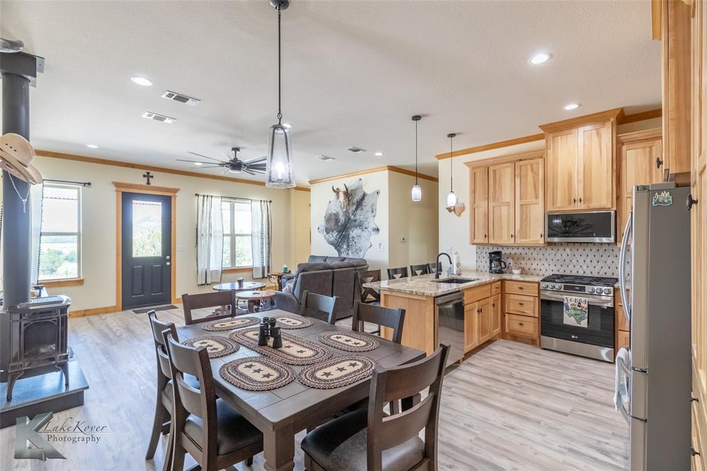 2302 County Road 360 Merkel, TX 79536 - Photo 33 of 39 a large kitchen with a table chairs stove and kitchen island