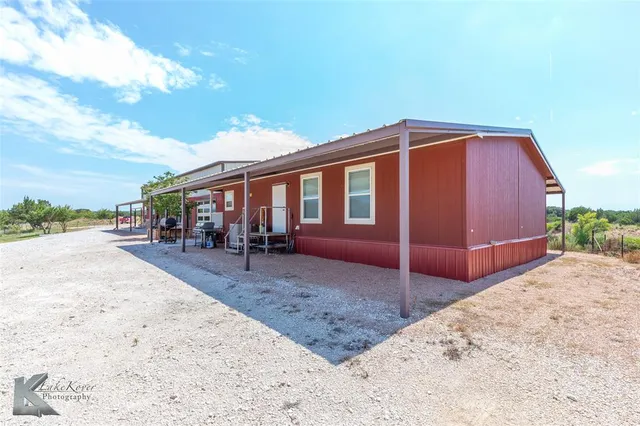 a view of a house with wooden fence