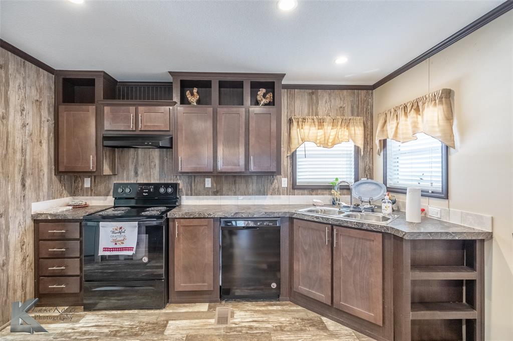 2302 County Road 360 Merkel, TX 79536 - Photo 10 of 39 a kitchen with stainless steel appliances granite countertop a stove a sink and a microwave