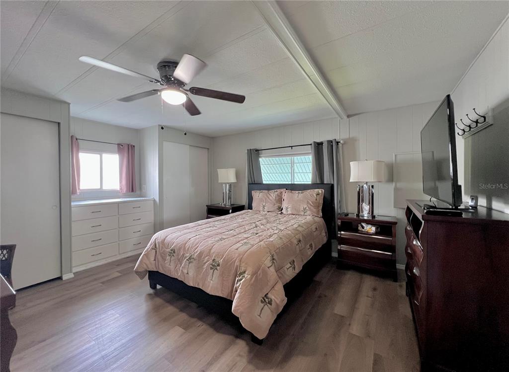 1100 South Belcher Road, Unit 772 Largo, FL 33771 - Photo 34 of 84 a bedroom with a bed and wooden floor