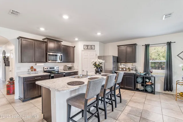 a kitchen with appliances a sink a counter top space and appliances