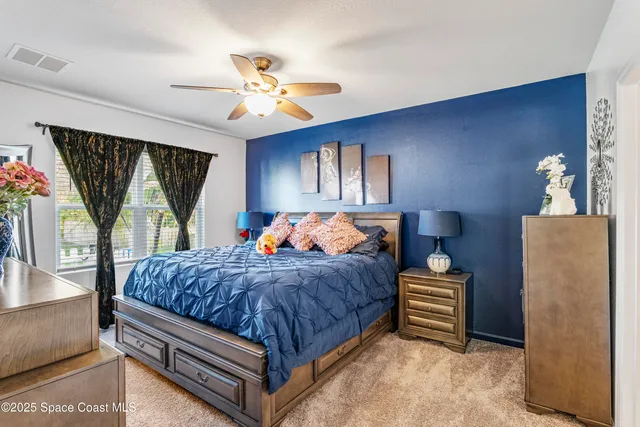 a bedroom with a bed dresser and a window