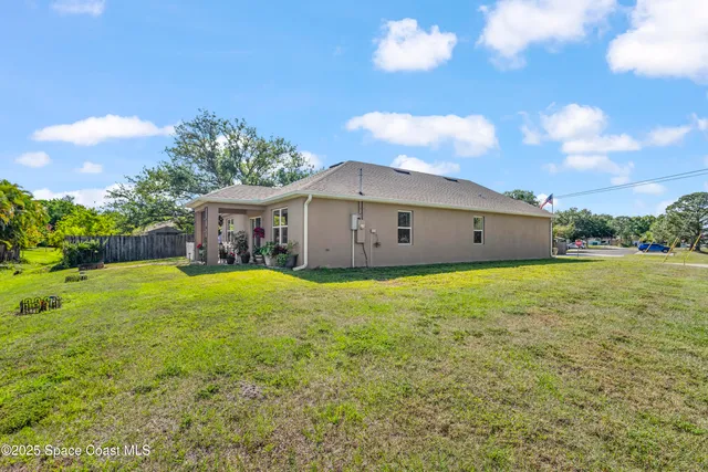 a view of a house with a backyard and a garden