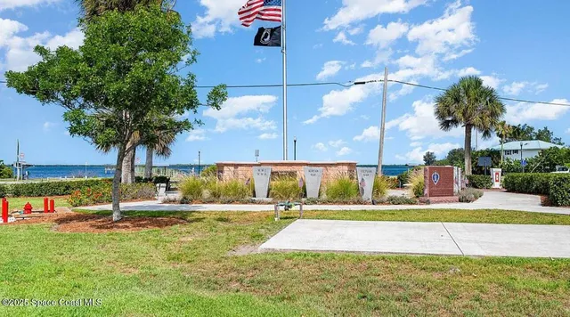 a view of a swimming pool with a yard