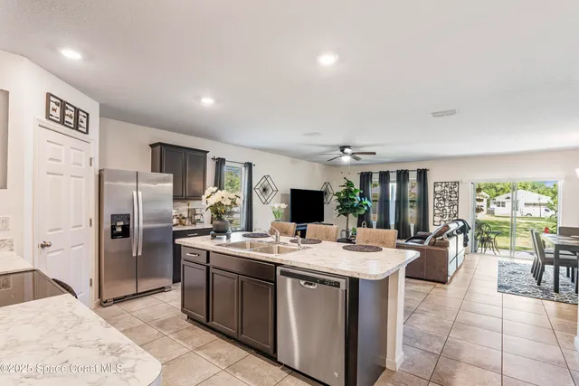 a kitchen with a sink stainless steel appliances and cabinets