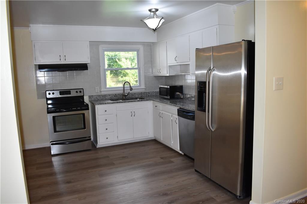 3816 Farmview Road Charlotte, NC 28205 - Photo 5 of 11 a kitchen with granite countertop a refrigerator and a sink