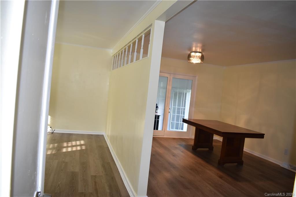 3816 Farmview Road Charlotte, NC 28205 - Photo 6 of 11 a view of a hallway with wooden floor and staircase