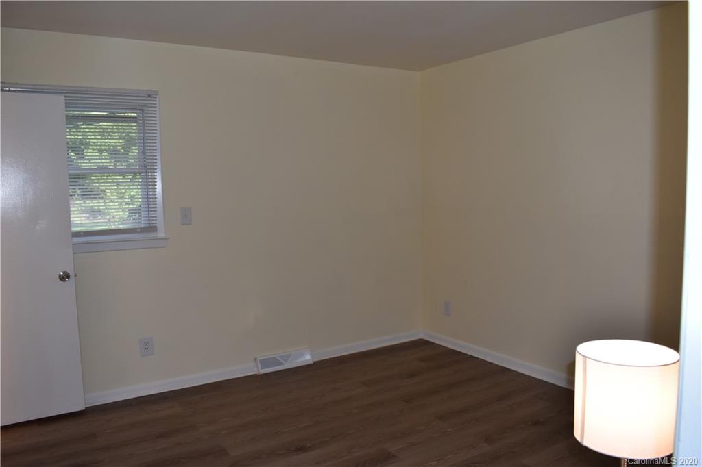 3816 Farmview Road Charlotte, NC 28205 - Photo 7 of 11 a view of an empty room with wooden floor and a window