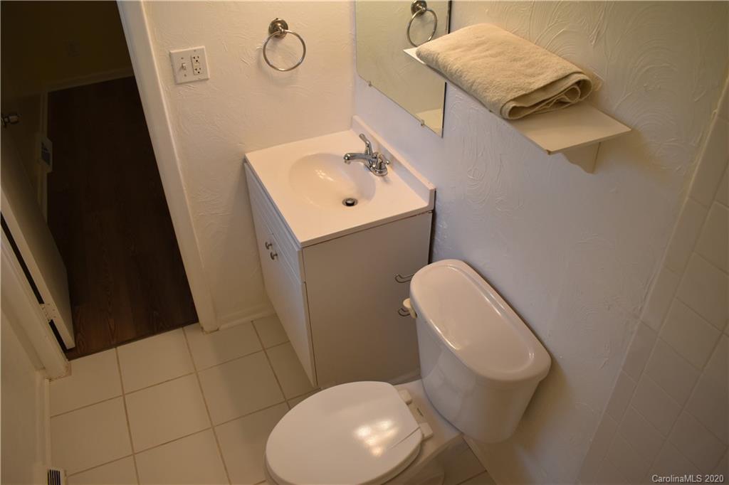 3816 Farmview Road Charlotte, NC 28205 - Photo 8 of 11 a bathroom with a toilet sink and mirror