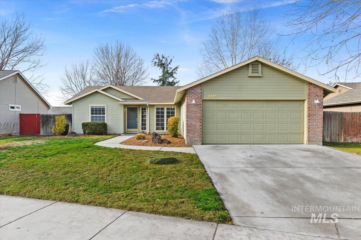 7415 North Matlock Avenue Boise, ID 83714 - Photo 1 of 1 Ranch-style house featuring concrete driveway, brick siding, an attached garage, and roof with shingles