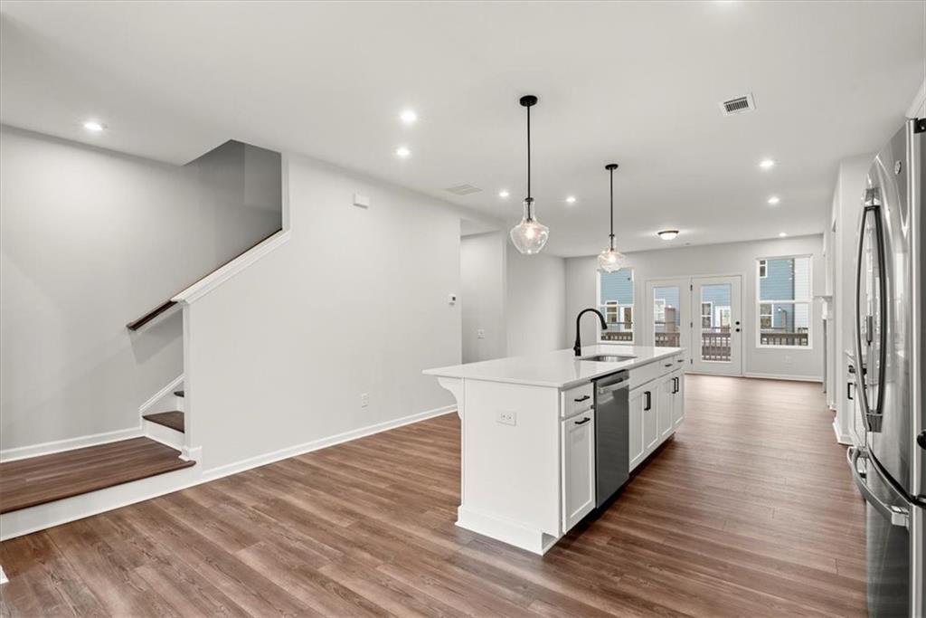 741 Payton Lane Acworth, GA 30102 - Photo 13 of 36 a large kitchen with stainless steel appliances kitchen island a large counter top and a wooden floors