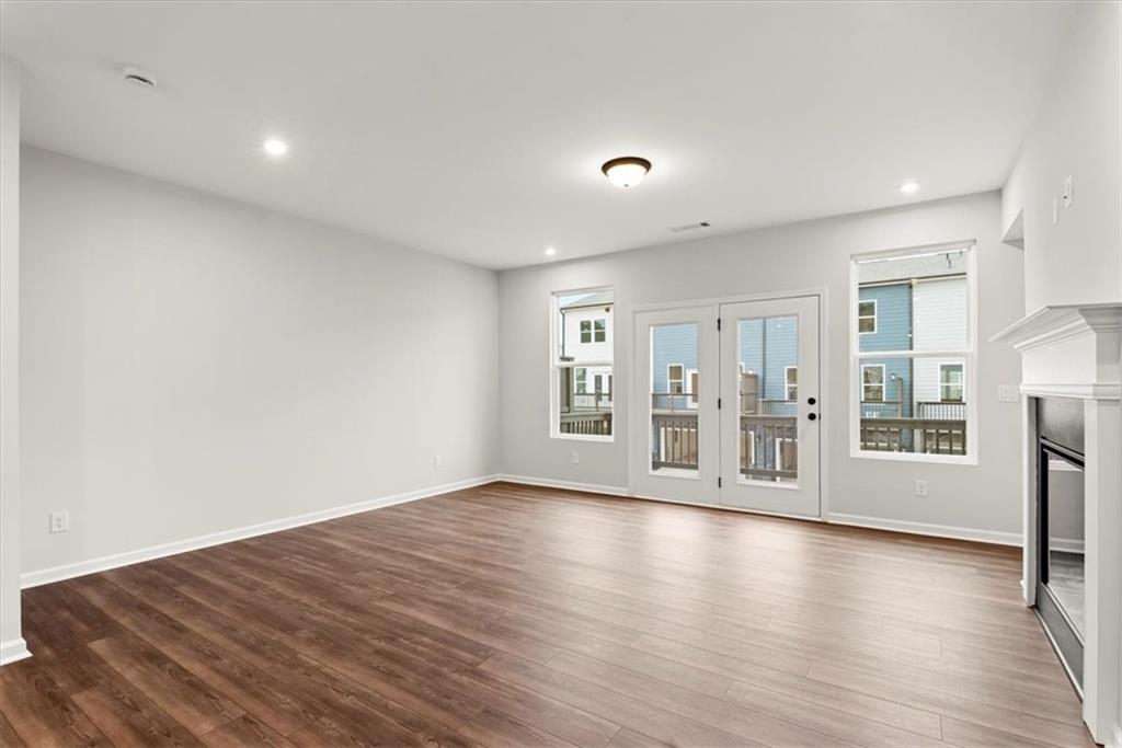 741 Payton Lane Acworth, GA 30102 - Photo 14 of 36 a view of an empty room with wooden floor and a window