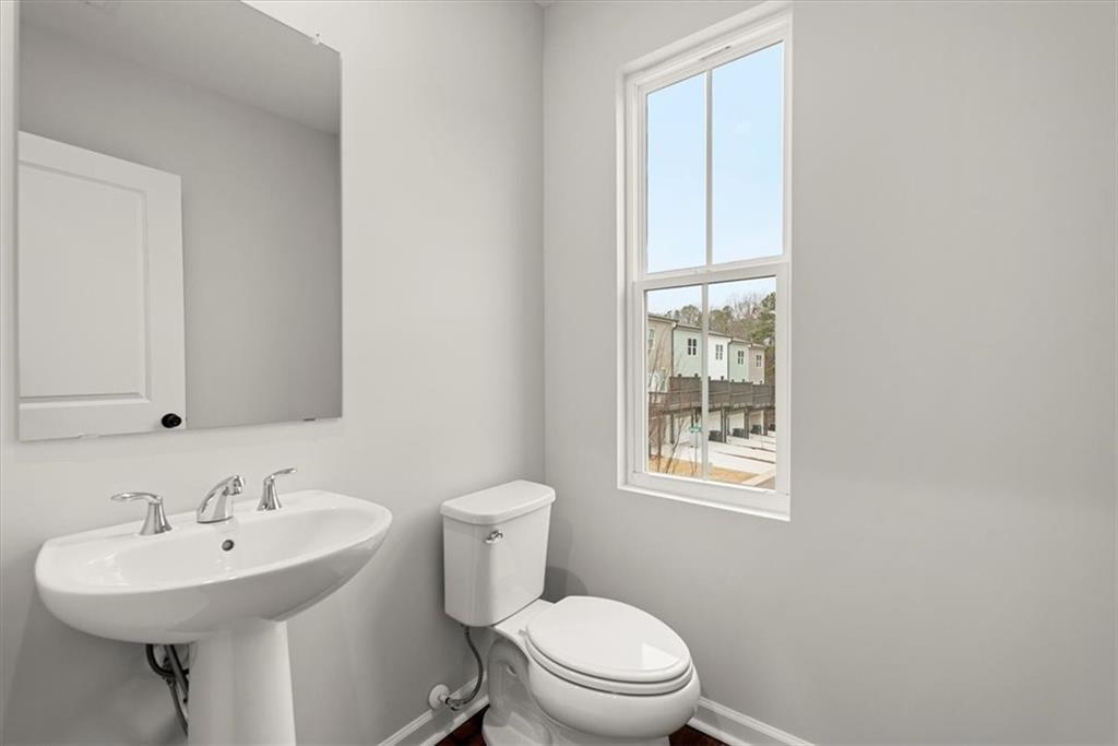 741 Payton Lane Acworth, GA 30102 - Photo 22 of 36 a bathroom with a sink a toilet and mirror