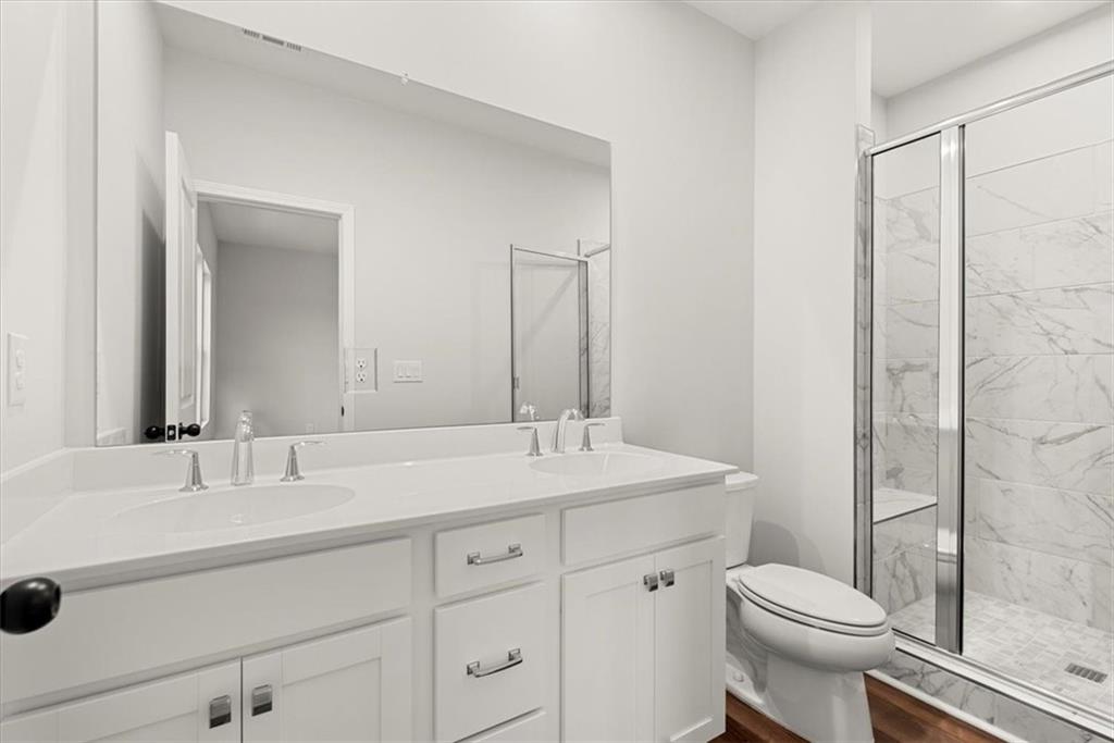 741 Payton Lane Acworth, GA 30102 - Photo 28 of 36 a bathroom with a sink toilet vanity and shower