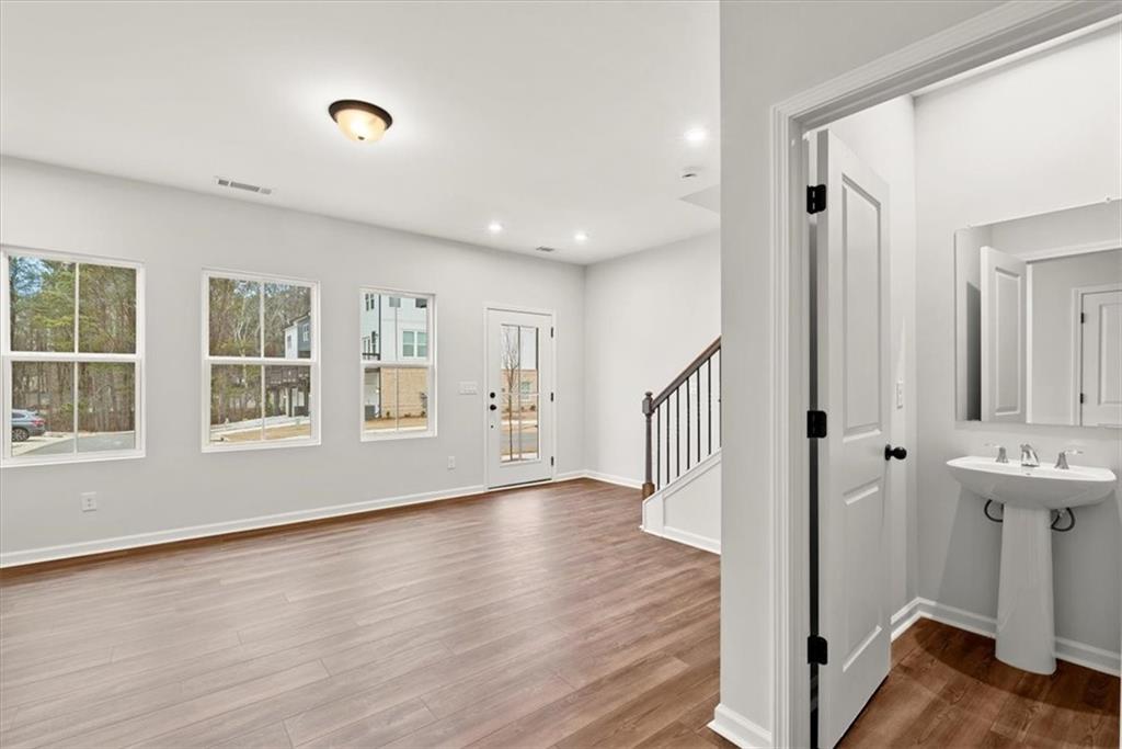 741 Payton Lane Acworth, GA 30102 - Photo 8 of 36 an empty room with wooden floor and windows