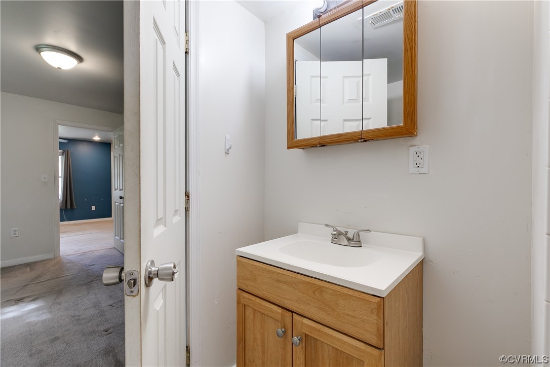 4144 Broad St Road Gum Spring, VA 23065 - Photo 14 of 34 a bathroom with a sink and a mirror