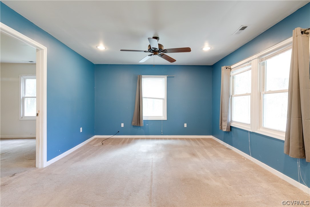 4144 Broad St Road Gum Spring, VA 23065 - Photo 9 of 34 an empty room with windows and chandelier fan