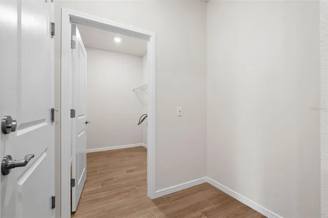 a view of a room with wooden floor