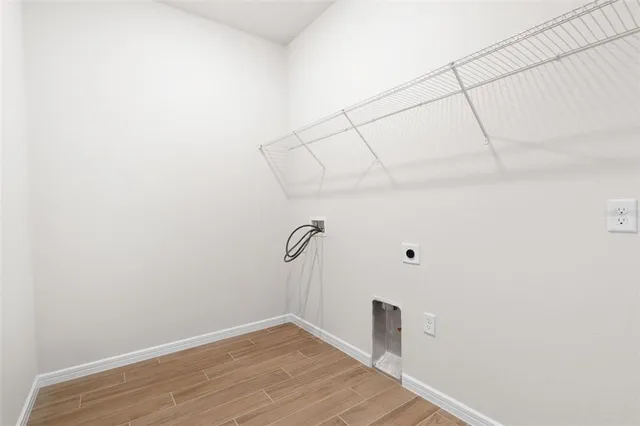 a large white kitchen with a large window a sink and stainless steel appliances