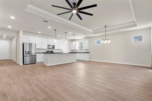 a kitchen with granite countertop white cabinets and a window