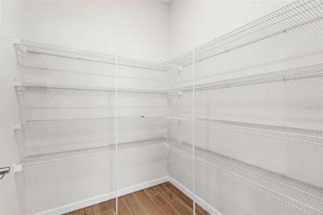 a spacious bathroom with a double vanity sink a large mirror and shower