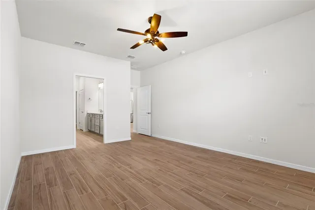 a white toilet sitting next to a white wall