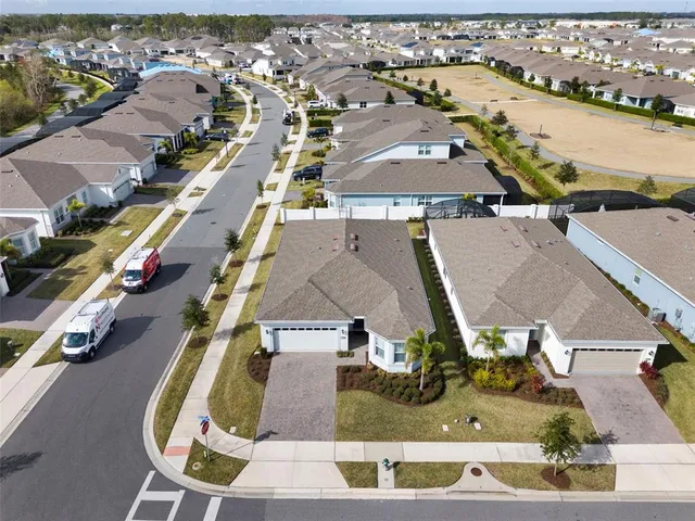 an aerial view of residential houses with outdoor space