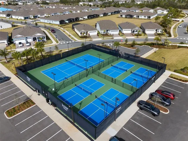 a roof deck with a couple of couches and potted plants