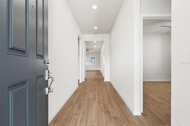 a view of a hallway with wooden floor