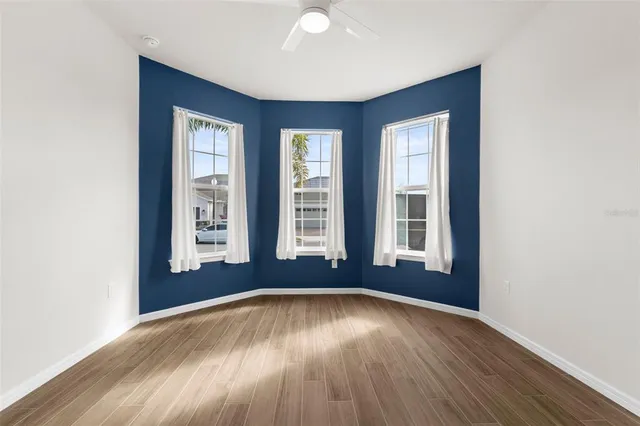 a view of an empty room with wooden floor