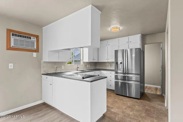 a kitchen with stainless steel appliances granite countertop a stove a refrigerator and a sink