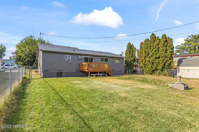 a swimming pool with yard and outdoor seating