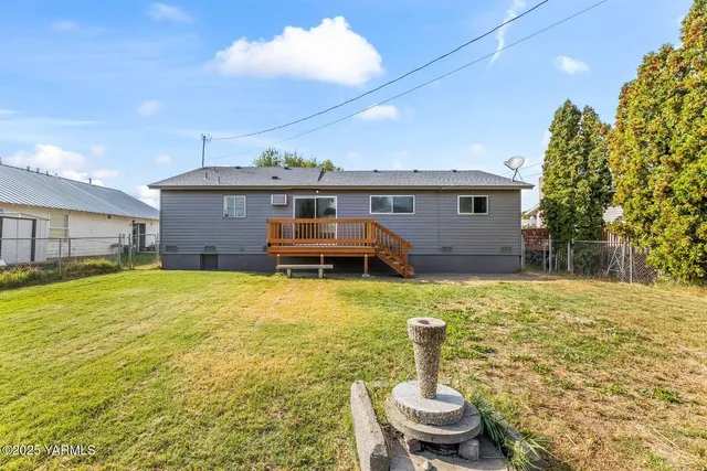 a swimming pool with outdoor seating and yard
