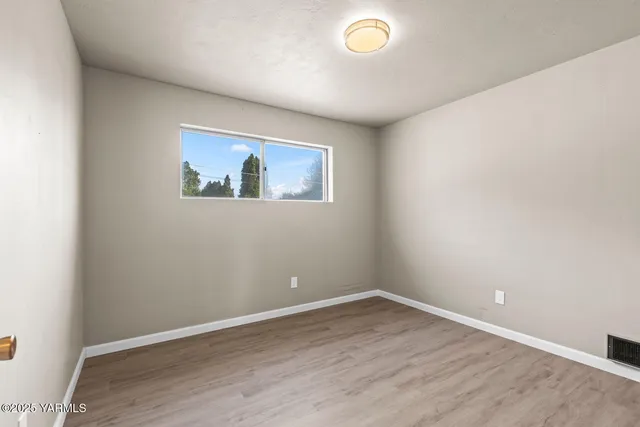 an empty room with wooden floor