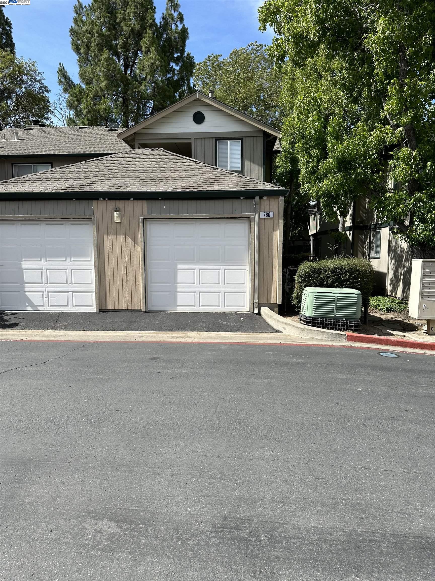 a front view of a house with a parking space