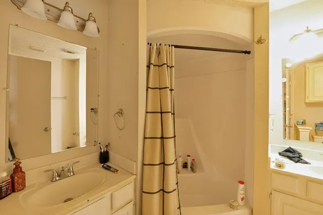 a bathroom with a sink and a shower